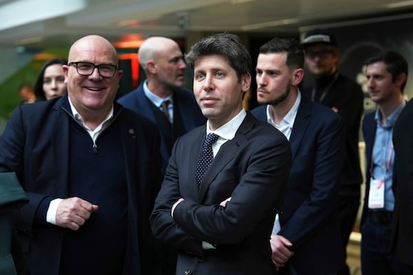 Sam Altman, CEO of OpenAI, center, at Station F, during an event on the sidelines of the Artificial Intelligence Action Summit in Paris, Tuesday, Feb. 11, 2025. (AP Photo/Aurelien Morissard, Pool)