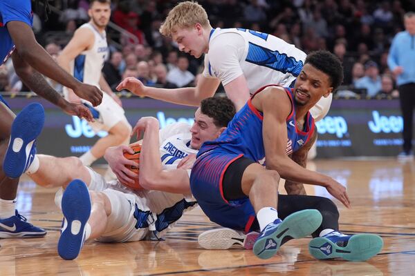 Creighton's Ryan Kalkbrenner (11) fights for control of the ball with DePaul's CJ Gunn (11) as teammate Jackson McAndrew watches during the second half of an NCAA college basketball game at the Big East basketball tournament Thursday, March 13, 2025, in New York. (AP Photo/Frank Franklin II)