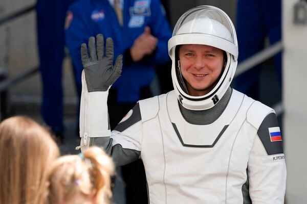 Cosmonaut Kirill Peskov waves as he leaves the Operations and Checkout building before heading to Launch Pad 39-A at the Kennedy Space Center in Cape Canaveral, Fla., for a mission to the International Space Station in Cape Canaveral, Fla., Friday, March 14, 2025. (AP Photo/John Raoux)