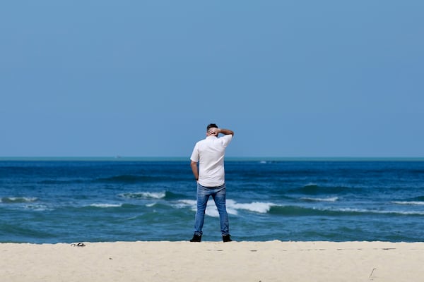 A relative of victim of a 2004 Indian Ocean tsunami stands at Ban Nam Khem beach, Takuapa district of Phang Nga province, southern Thailand, Thursday, Dec. 26, 2024. (AP Photo/Wason Wanichakorn)