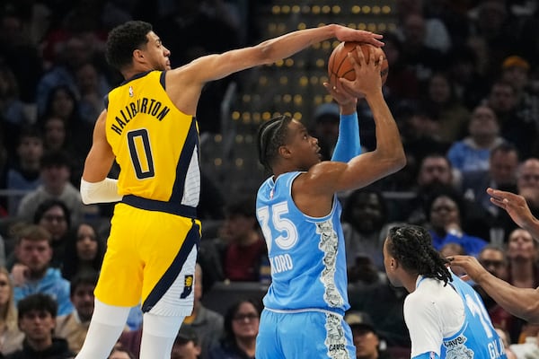 Indiana Pacers guard Tyrese Haliburton (0) blocks a shot by Cleveland Cavaliers forward Isaac Okoro (35) on the first half of an NBA basketball game, Sunday, Jan. 12, 2025, in Cleveland. (AP Photo/Sue Ogrocki)