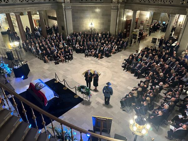 Missouri Gov. Mike Kehoe and first lady Claudia Kehoe pay their respects at a memorial service for former Missouri Gov. and U.S. Sen. Christopher Kit Bond at the state Capitol on Tuesday, May 20, 2025, in Jefferson City, Mo. (AP Photo/David A. Lieb)