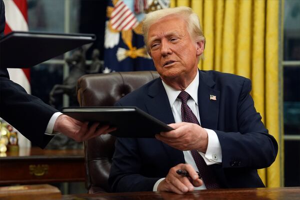 FILE - President Donald Trump signs executive orders in the Oval Office of the White House, Jan. 20, 2025, in Washington. (AP Photo/Evan Vucci, File)