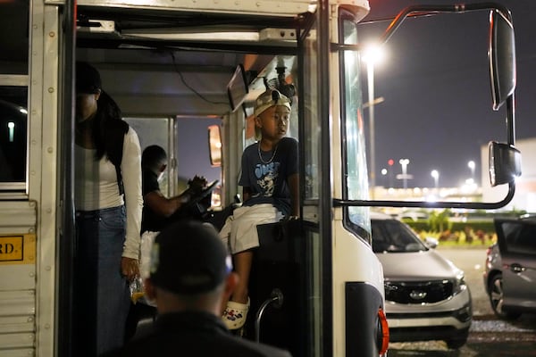 A Vietnamese boy traveling with his mother and other migrants who were held in a Panamanian immigration temporary shelter after being deported from the U.S. arrives in Panama City, Saturday, March 8, 2025, after authorities gave them 30 days to leave the country. (AP Photo/Matias Delacroix)