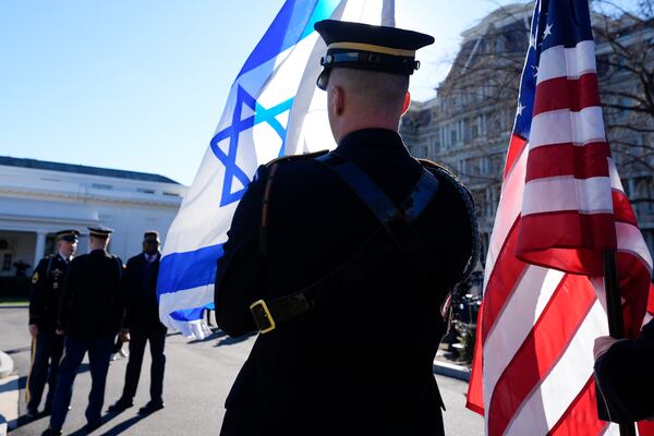 Flags are prepared for the arrival of Israeli Prime Minister Benjamin Netanyahu outside the East Wing of the White House, Tuesday, Feb. 4, 2025, in Washington. (AP Photo/Alex Brandon)