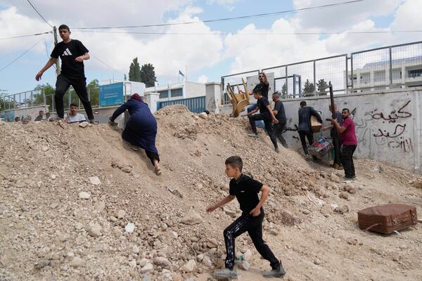 Residents of the now evacuated refugee camp of Tulkarem return to collect belongings before the destruction of their homes as Israeli forces prepare to carry out the demolition of 116 homes across the two refugee camps of the Israeli occupied West Bank city of Tulkarem, Friday, May 2, 2025. (AP Photo/Nasser Nasser)