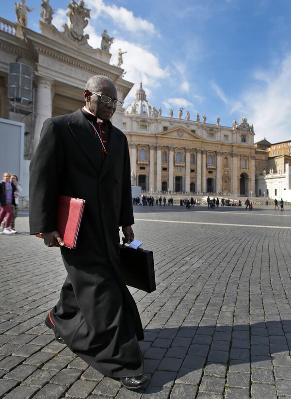 FILE - In this March 4, 2013 file photo, Cardinal Robert Sarah, of Guinea, walks in St. Peter's Square after attending a cardinals' meeting, at the Vatican. (AP Photo/Andrew Medichini, File)