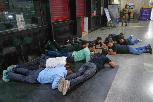Civil defense members carry out a mock drill at a metro station to train civilians and security personnel to respond in case of attack, in New Delhi, India, Wednesday, May 7, 2025. (AP Photo/Manish Swarup)