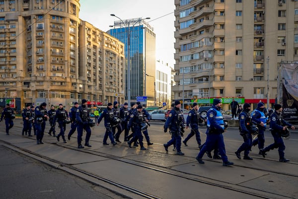 Gendarmes walk during a rally organized by the right wing Alliance for the Unity of Romanians (AUR), calling for free elections after Romania' s Constitutional Court annulled the first round of presidential elections last December, in Bucharest, Romania, Sunday, Jan. 12, 2025. (AP Photo/Vadim Ghirda)