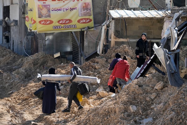 Residents of the West Bank urban refugee camp of Nur Shams evacuate their homes and carry their belongings as the Israeli military continues its operation in the area on Wednesday, Feb. 26, 2025. (AP Photo/Majdi Mohammed)