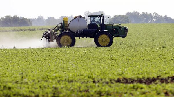 FILE - A soybean field is sprayed in Iowa, July 11, 2013. (AP Photo/Charlie Neibergall, File)