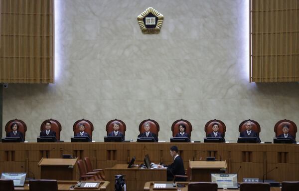 South Korea's Supreme Court Chief Justice Cho Hee-dae, center, and other justices are seated in the courtroom to attend a hearing to hand down a ruling on the election law violation case of the Democratic Party presidential candidate Lee Jae-myung in Seoul, South Korea, Thursday, May 1, 2025. (Yonhap via AP)