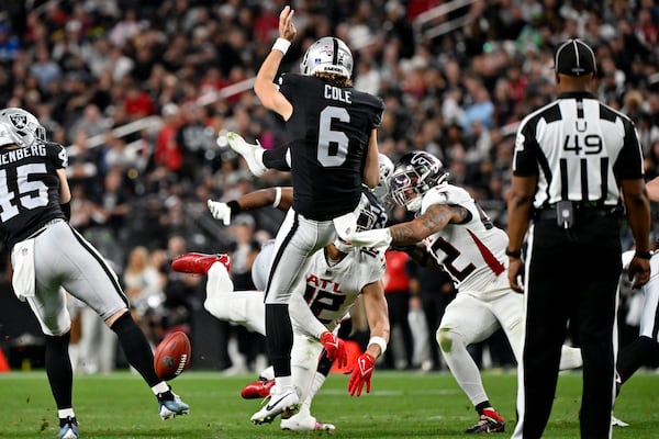 Atlanta Falcons' KhaDarel Hodge (12) blocks the punt of Las Vegas Raiders punter AJ Cole (6) during the second half of an NFL football game, Monday, Dec. 16, 2024, in Las Vegas. (AP Photo/David Becker)