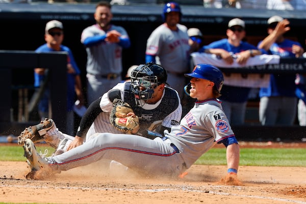 New York Mets' Brett Baty (7) reacts after being tagged out by New York Yankees catcher J.C. Escarra at home plate during the seventh inning of a baseball game, Saturday, May 17, 2025, in New York. (AP Photo/Noah K. Murray)
