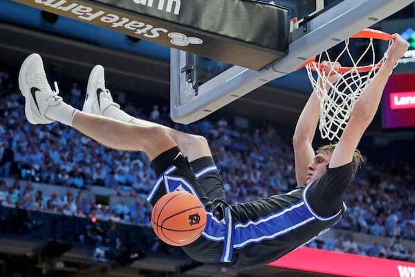 Duke forward Cooper Flagg (2) dunks during the second half of an NCAA college basketball game against North Carolina, Saturday, March 8, 2025, in Chapel Hill, N.C. (AP Photo/Chris Seward)