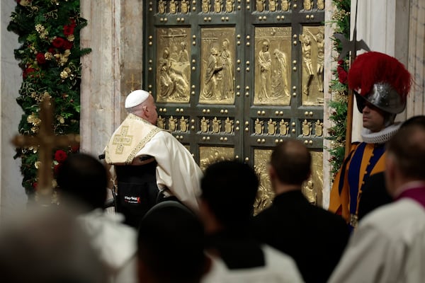 Pope Francis opens the Holy Door to mark the opening of the 2025 Catholic Holy Year, or Jubilee, in St. Peter's Basilica, at the Vatican, Dec. 24, 2024. (Remo Casilli/Pool Photo via AP)