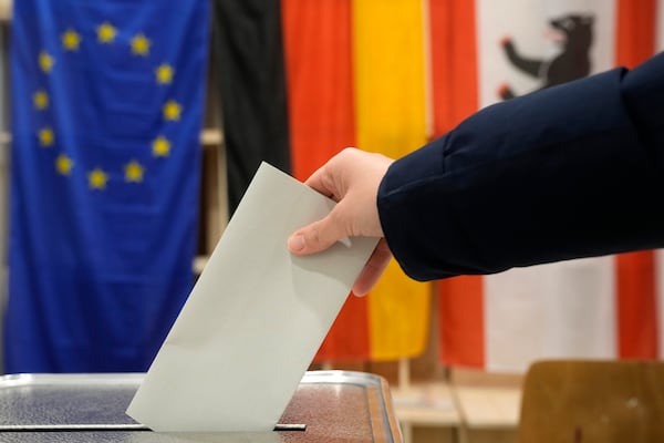 A resident casts a vote at a polling station in Berlin, Germany, Sunday, Feb. 23, 2025, during the German national election. (AP Photo/Michael Probst)