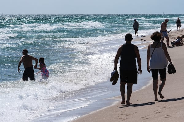 Beachgoers enjoys the warm weather Wednesday, Feb. 12, 2025, in Fort Lauderdale, Fla. (AP Photo/Marta Lavandier)