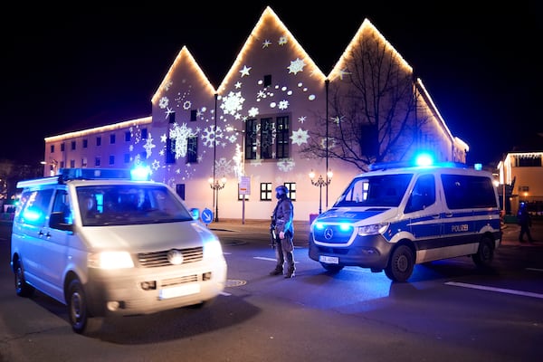 A police officer guards at a blocked road near a Christmas Market, after an incident in Magdeburg, Germany, Friday, Dec. 20, 2024. (AP Photo/Ebrahim Noroozi)