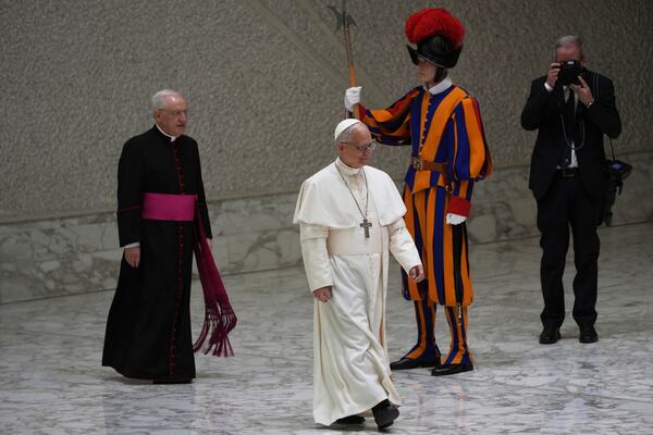 Pope Leo XIV arrives as he meets members of the international media in the Paul VI Hall at the Vatican, Tuesday, May 13, 2025. (AP Photo/Domenico Stinellis)