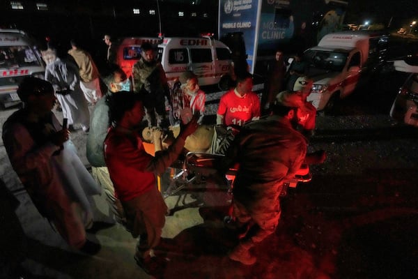 An injured passenger, rescued by security forces from a passenger train attacked by insurgents, is carried on a stretcher after arriving on a special train for the wounded and survivors, organized by the army, at a railway station in Much, in Pakistan's southwestern Balochistan province, Wednesday, March 12, 2025. (AP Photo/Anjum Naveed)