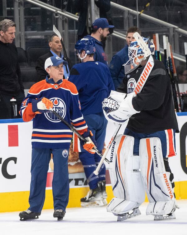 Canadian Prime Minister Mark Carney skates with Edmonton Oilers goalie Stuart Skinner (74) at the NHL hockey team's practice during a visit to Edmonton, Alberta, Thursday, March 20, 2025. (Jason Franson/The Canadian Press via AP)