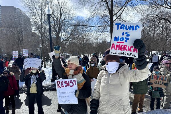 Demonstrators join more than a thousand people protesting the policies of the Trump administration marched from the Boston Common past City Hall to the North End, Monday, Feb. 17, 2025 in Boston. (AP/Michael Casey)