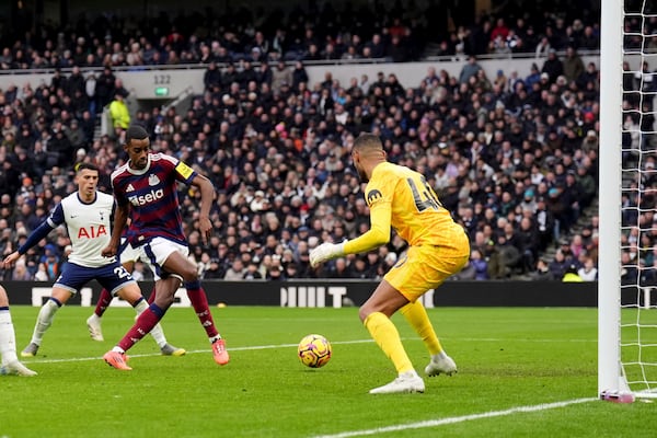 Newcastle United's Alexander Isak score past Tottenham's Brandon Austin during the English Premier League soccer match between Tottenham Hotspur and Newcastle United at the Tottenham Hotspur Stadium, London, Saturday Jan. 4, 2025. (John Walton/PA via AP)