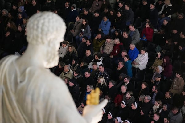 People attend a rosary prayer with Cardinal Victor Manuel Fernandez held for the health of Pope Francis in St Peter's Square at the Vatican, Friday, Feb. 28, 2025. (AP Photo/Andrew Medichini)