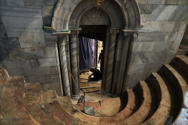 Workers tend to stairs in the Church of the Nativity, where Christians believe Jesus Christ was born, ahead of Christmas in the West Bank city of Bethlehem, Tuesday, Dec. 17, 2024. (AP Photo/Mahmoud Illean)