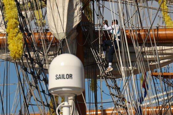 While docked at Pier 35, Sunday, May 18, 2025 in New York, a sailor climbs the mast rigging on the Cuauhtémoc, a masted Mexican Navy training ship that collided with the Brooklyn Bridge the night before. (AP Photo/Yuki Iwamura)