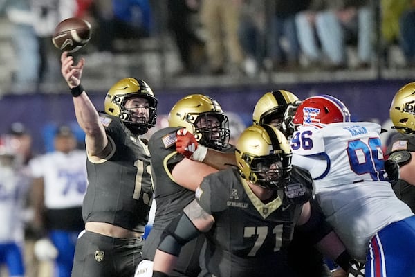 Army quarterback Bryson Daily (13) passes against rushing Louisiana Tech defensive lineman Zion Nason (96) during the first half of the Independence Bowl NCAA college football game, Saturday, Dec. 28, 2024, in Shreveport, La. (AP Photo/Rogelio V. Solis)