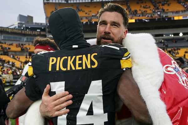 Kansas City Chiefs tight end Travis Kelce (87) and Pittsburgh Steelers wide receiver George Pickens (14) embrace after an NFL football game, Wednesday, Dec. 25, 2024, in Pittsburgh. (AP Photo/Matt Freed)