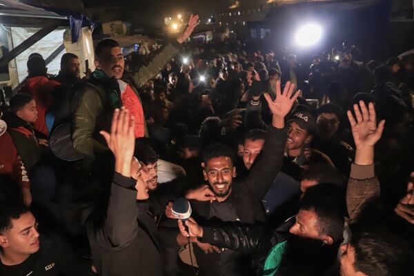 Palestinians celebrate the imminent announcement of a ceasefire deal between Hamas and Israel in Khan Younis, central Gaza Strip, Wednesday, Jan. 15, 2025.(AP Photo/(AP Photo/Mariam Dagga)