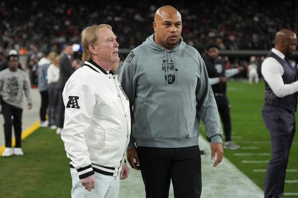 Las Vegas Raiders owner Mark Davis talks with head coach Antonio Pierce, right, prior to an NFL football game against the Atlanta Falcons, Monday, Dec. 16, 2024, in Las Vegas. (AP Photo/Rick Scuteri)