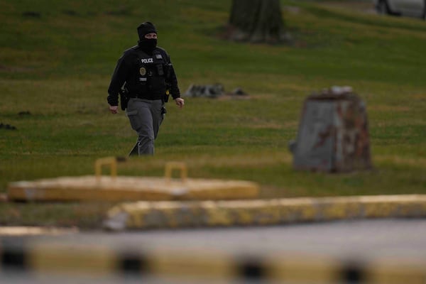 A police officer walks outside of Indiana State Prison where, barring last-minute court action or intervention by Gov. Eric Holcomb, Joseph Corcoran, 49, convicted in the 1997 killings of his brother and three other people, is scheduled to be put to death by lethal injection before sunrise Tuesday, Dec. 17, 2024, in Michigan City, Ind. (AP Photo/Erin Hooley)