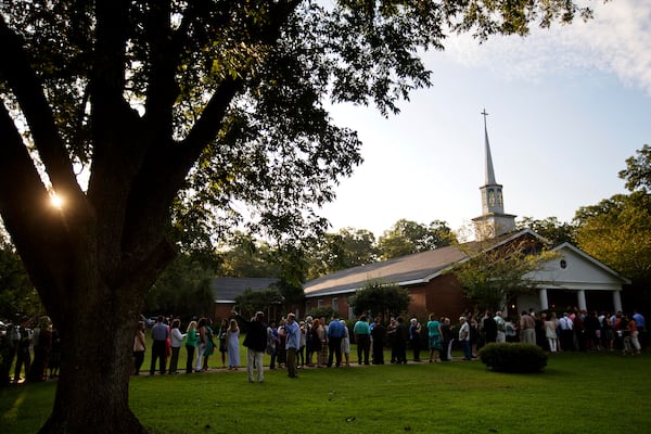 FILE - People wait in line outside Maranatha Baptist Church in Plains, Ga., to get into a Sunday school class taught by former U.S. President Jimmy Carter on Aug. 23, 2015. It was Carter's first lesson since announcing plans for intravenous drug doses and radiation to treat melanoma found in his brain after surgery to remove a tumor from his liver. (AP Photo/David Goldman, File)