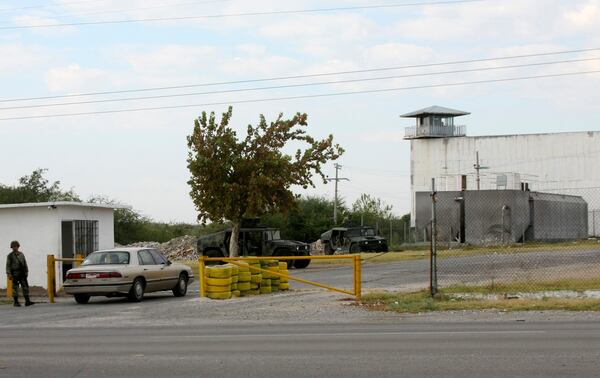 FILE - Soldiers guard an entrance to the state prison in Piedras Negras, Mexico, Sept. 18, 2012. (AP Photo/Adriana Alvarado, File)