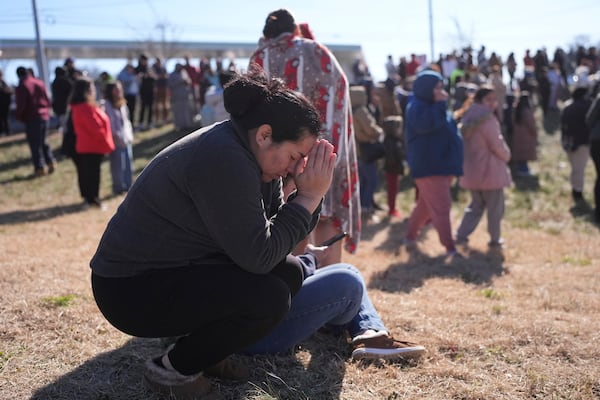 Dasia Pleitez prays as she waits for her daughter at a unification site following a shooting at the Antioch High School in Nashville, Tenn., Wednesday, Jan. 22, 2025. (AP Photo/George Walker IV)