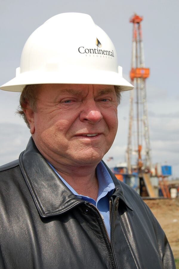 FILE - Billionaire oilman Harold Hamm stands for a portrait by an oil rig near Watford City, N.D., on April 30, 2009. (AP Photo/James MacPherson, File)