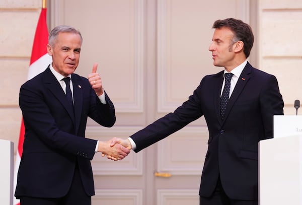 Canada Prime Minister Mark Carney, left, gives a thumbs up as he shakes hands with President of France Emmanuel Macron after delivering a joint statement at the Palais de l'Elysee in Paris, on Monday, March 17, 2025. (Sean Kilpatrick/The Canadian Press via AP)