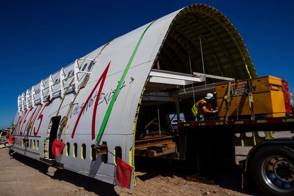 A section of a 747 airplane moves through Las Vegas streets on the way to a new home at Area 15 where it will be part of an immersive art display, on Wednesday, Feb. 26, 2025. (AP Photo/Ty ONeil)