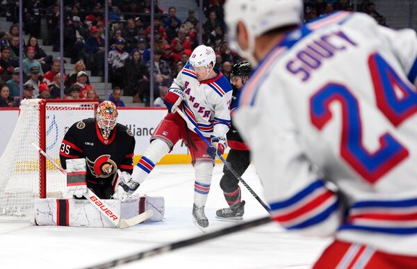 A shot by New York Rangers' Carson Soucy (24) gets through the five-hole of Ottawa Senators goaltender Linus Ullmark (35) for a goal during the first period of an NHL hockey game in Ottawa, Ontario, Saturday, March 8, 2025. (Justin Tang/The Canadian Press via AP)