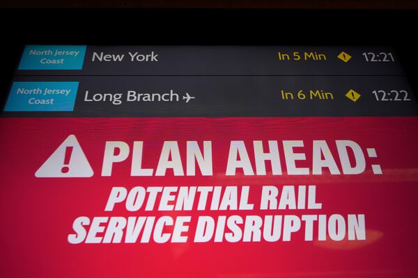 An electronic display advises commuters of potential NJ Transit service disruptions at the Secaucus Junction station in Secaucus, N.J., Wednesday, May 14, 2025. (AP Photo/Seth Wenig)