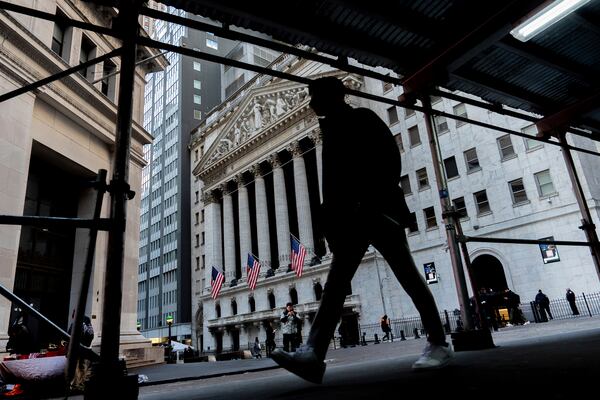 People walk past the New York Stock Exchange, Tuesday, Jan. 28, 2025, in New York. (AP Photo/Julia Demaree Nikhinson)