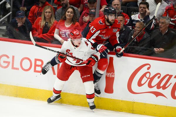 Carolina Hurricanes right wing Jackson Blake (53) and Washington Capitals right wing Tom Wilson (43) collide in the third period of Game 1 of a second-round NHL hockey playoff series Tuesday, May 6, 2025, in Washington. (AP Photo/Nick Wass)