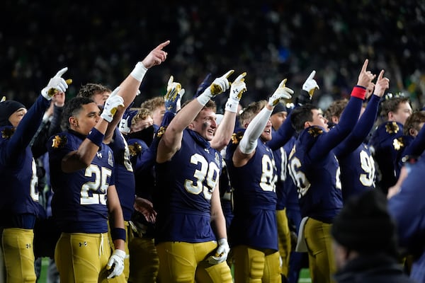 Notre Dame players celebrate after beating Indiana 27-17 in the first round of the NCAA College Football Playoff, Friday, Dec. 20, 2024, in South Bend, Ind. (AP Photo/Darron Cummings)