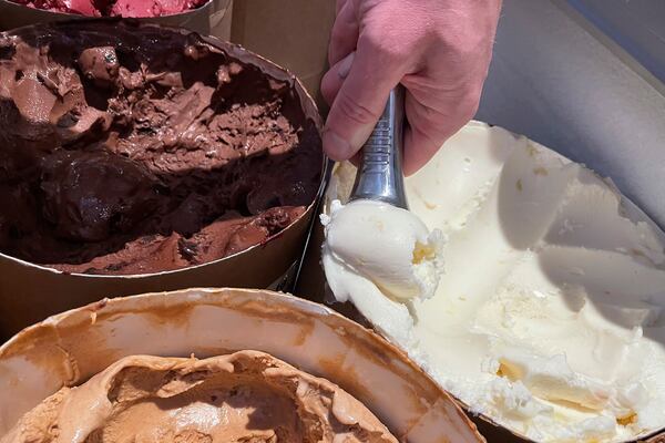 FILE - Salt & Straw Ice Cream Co-Founder Tyler Malek scoops "Day-Old Bread Pudding" upcycled ice cream in Los Gatos, Calif., on June 2, 2023. (AP Photo/Haven Daley, File)