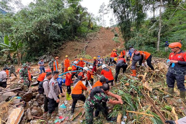 Rescuers search for victims at the site of a landslide in Pekalongan, Central Java, Indonesia, Thursday, Jan. 23, 2025. (AP Photo/Janaki DM)