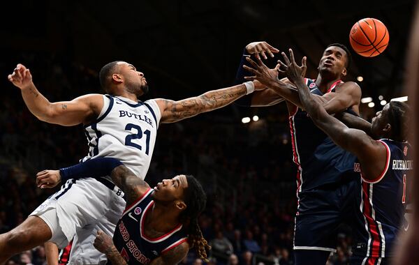 Butler ath Dante Maddox Jr. (21) knocks a rebound away from St. John's center Vince Iwuchukwu during the first half of an NCAA college basketball game, Wednesday, Feb. 26, 2025, in Indianapolis, Ind. (AP Photo/Marc Lebryk)